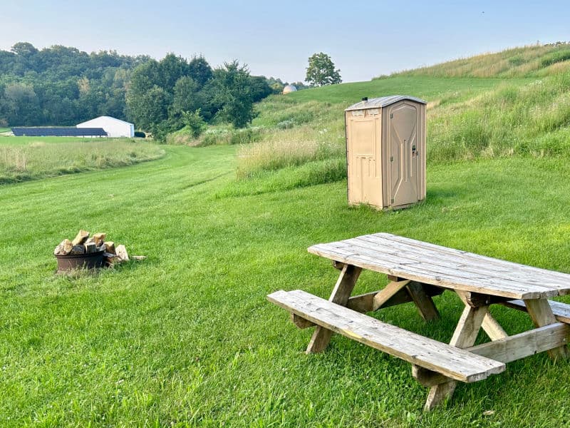 Campsite 2 offers a picnic table, bonfire area, and is less than 400 feet from White Barn where there is a bathroom with warm shower.