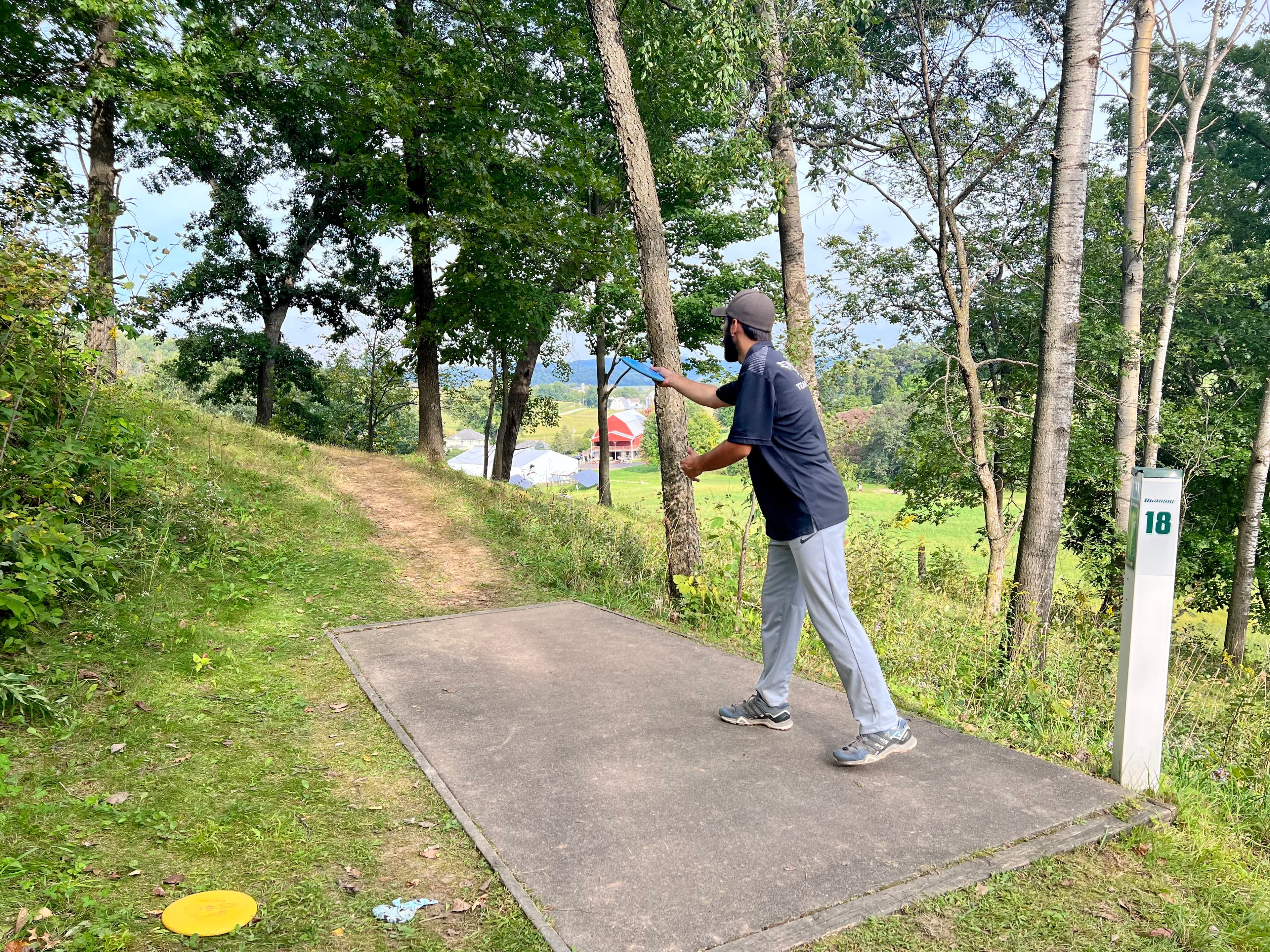 A man throwing a disc golf disc