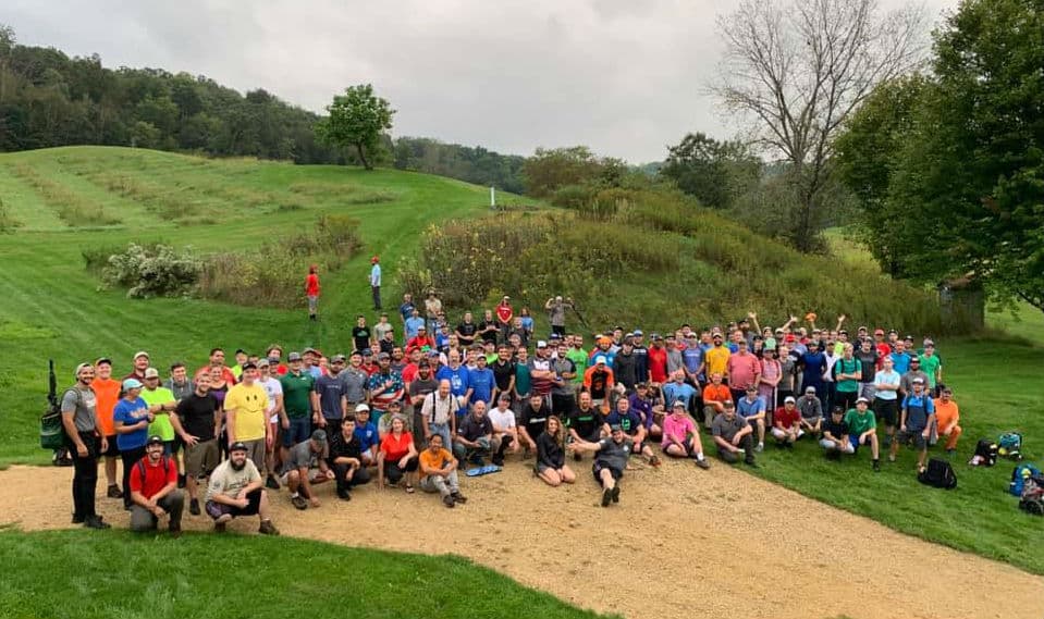 A group of 151 disc golf players ready to play a disc golf tournament