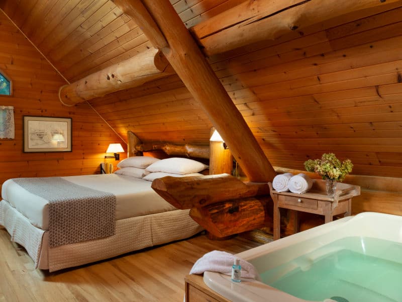 Upstairs loft with aspen wood beams and natural wood walls & floors, king bed and whirlpool tub.