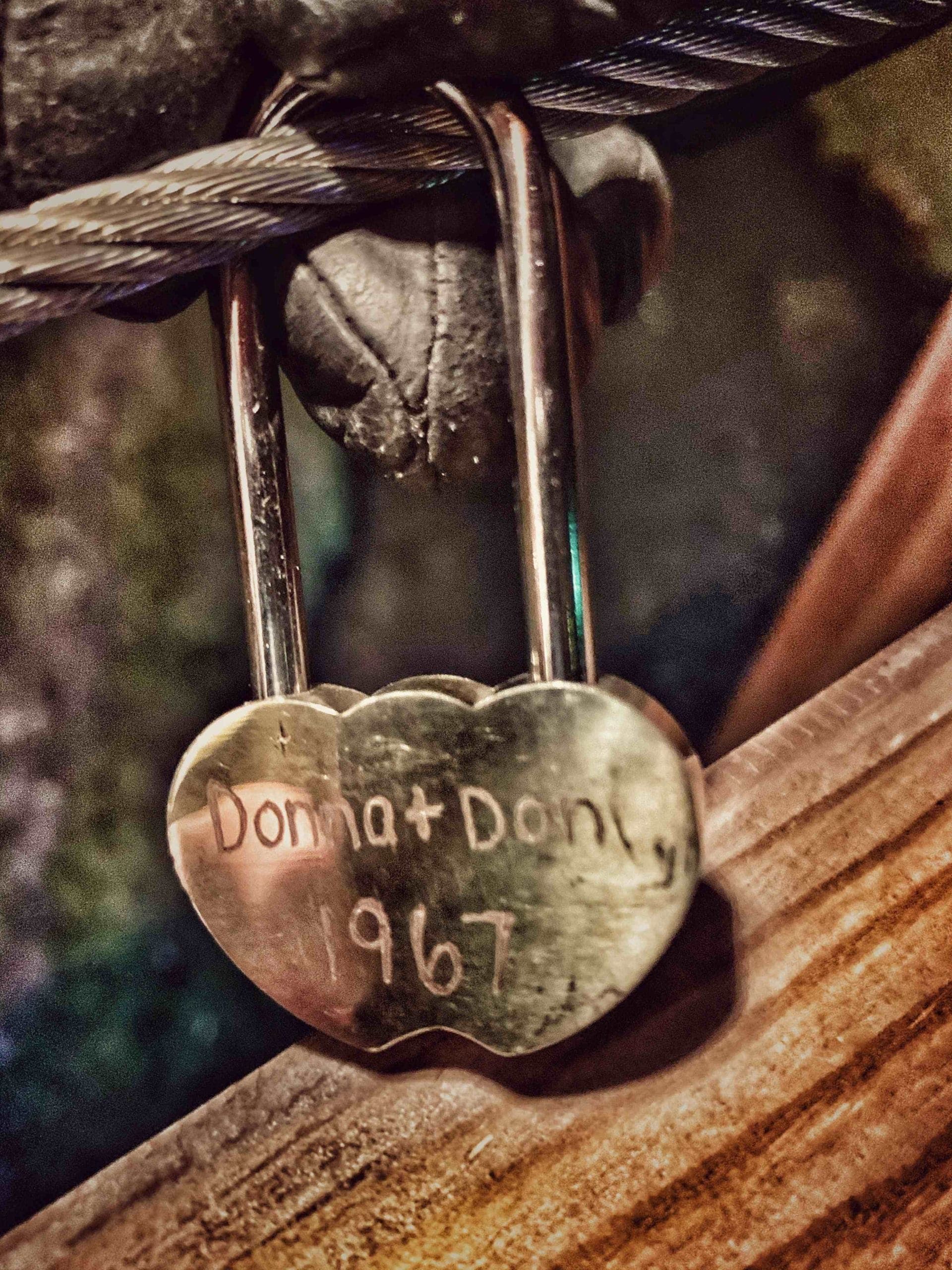 A heart-shaped lock engraved with the names "Donna + Don" and the year "1967."