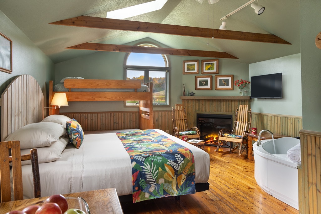 Bedroom with a dining table, kitchen, and bed